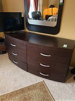 Front angle showing the dresser, six drawers with silver handles and dark wood finish.