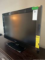 Front angled view of a black Hisense television showing the screen and attached stand.