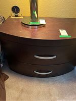 Front view of brown wooden night stand showing two drawers with chrome handles