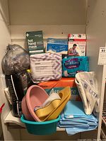 Overview of the lot showing multiple packages of medical briefs, hospital pans, and disposable pads.