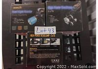 Photo of three boxed Boruit high power headlamps on a black grid surface with stickers and text visible.