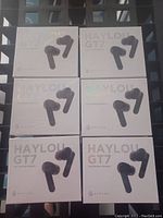 Six sealed boxes of Haylou GT7 true wireless earbuds arranged in two columns and three rows, photographed in natural light.