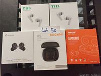 Photo of 5 boxed pairs of wireless earbuds from different brands.