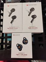Front view of 2 boxed Monster Clarity 102 Plus Airlinks and 1 boxed Monster Clarity 101 Airlinks earbuds