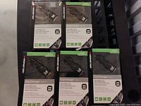 Five boxed Monster iCarCharger MAX 2 car chargers displayed on a black surface
