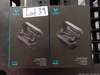 Photo of two unopened boxes of Rapoo VM700 Bluetooth TWS Gaming Earbuds, showing front box art of the earbuds and charging case in black color.