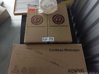 Photo showing two Adams Polishes boxes, one Renpho Cordless Massager box, and one roll of Alien Tape on the top, all boxed and unopened.