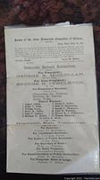 Front of original 1864 Democratic ticket for Illinois election showing names of candidates for presidential and state offices, printed on aged paper inside a plastic protective sleeve.