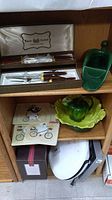 Regent Sheffield knife set with other kitchen and decorative items on wooden shelving