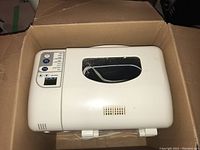 Top view of closed Breadman breadmaker showing white lid and digital control panel.