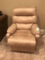 Front view of beige recliner chair in upright position