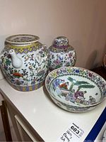 Photo showing the ginger jar, decorative bowl, and porcelain pot on a white surface, highlighting their size and painted details.