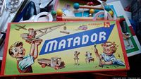 Closed Korbuly Matador box with artwork showing children and text Matador
