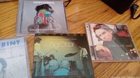 Three CD jewel cases: Simple Minds – Walk Between Worlds, Big Star – Live at the Shindig Music Room, Jesse Cook – Nomad