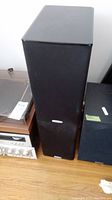 Front view of one black Polk Audio TSi200 floor-standing speaker with fabric grill and rectangular shape.