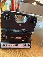 Canon PS-1000 Canosound 8mm film projector front view showing control panel and reel spindles