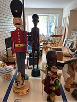 Overall lot showing the Reuge music box base with wooden figures and large soldier figure in background, plus other wood figures.