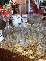 Photo showing the full set including punch bowl, cups, canisters, covered dish, platter, and tall fruit bowl on kitchen counter.