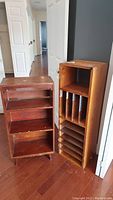 Overview of two wooden shelves standing side by side, showing different storage styles