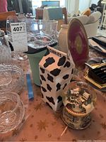 Photo showing the cookie jar, snow globe, and popcorn air popper placed together on a table.