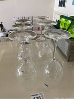 Six clear Bohemia crystal wine glasses shown upside down on a table, highlighting their shape and clarity.