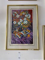 Full view of framed Paul Blaine Henrie print depicting vibrant floral still life and objects on cloth, signed and numbered below the image.