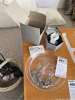 White Casio G-Shock watch in hexagonal metal case with original box and manual, silver plated thick chain necklace on etched glass tray with bird designs