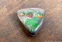 Top view showing triangular shape and enamel strawberry motif