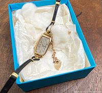 Full view of the antique ladies watch in its box with attached Victorian gold bracelet and padlock charm