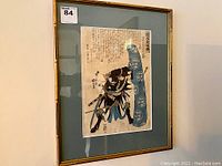 Framed print full view showing bamboo-style gold-tone frame and green mat.