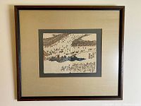 Framed woodblock print by Hiroshige hung on a wall, showing entire frame and mat
