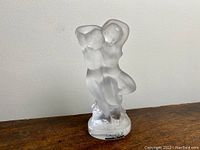 Front perspective of the Lalique frosted crystal figurine depicting two nude women dancing.