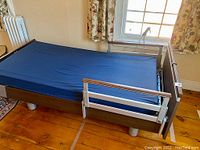 Full side view of twin-size adjustable bed with blue mattress installed