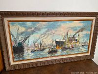 Full view of the signed nautical oil painting in its carved frame, showing seascape with ships under cloudy sky.