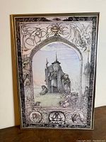 Framed Lord of the Rings print showing full artwork with Gandalf and key characters, with a detailed illustrative border and lettering.