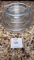 Stacked view of three clear glass Anchor Hocking Pyrex bowls on granite countertop.