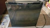 Front view of compact black Frigidaire refrigerator