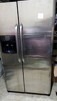 Front view of stainless steel side-by-side refrigerator/freezer with ice and water dispenser on left door