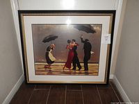 Full view of the framed picture depicting four people dancing under umbrellas with a reflective ground and cloudy sky background.