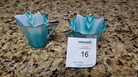Two-piece Noritake sugar and creamer set displayed on granite counter; star-shaped design with teal and white gradient and silver rim