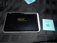 Acer tablet displaying startup screen with charger connected