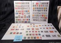 Overview of five pages of Canadian stamps laid out with some pages standing upright and others flat, showing a variety of denominations and designs.