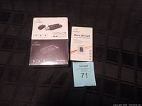 Overview photo showing the InfinitiKloud Wireless Micro SD Card Reader boxed, the USB Micro SD Card Reader packaging, and the 32GB Micro SD Card box alongside a lot number card.