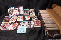 Full view of a large box filled with hockey trading cards mostly in long boxes and some loose stacks, showing a broad quantity of cards.