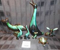 Photo showing six Blue Mountain Pottery animal figurines on a dark fabric background