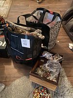 Photo showing two bags filled with various craft supplies including driftwood and wooden beads.