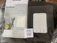 Box and lamp in packaging labeled Brookstone Daylight Therapy Lamp 5000 Lux