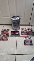 Lot of Star Wars, Transformers, and G.I. Joe figures arranged on floor with packaging visible