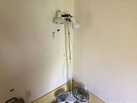 Full view of the dual light floor lamp with two fans on the floor nearby, showing condition and setup.