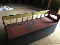 Full view of the vintage painted wooden toy box showing color scheme and overall condition.
